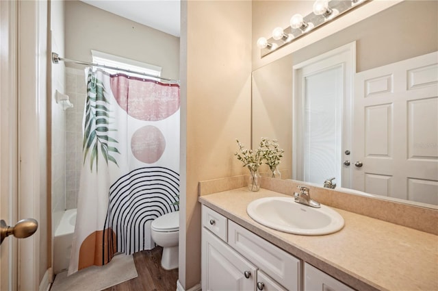 6339 Alamanda Hills Dr, Lakeland, FL 33813 - full bathroom with vanity, toilet, shower / bathtub combination with curtain, and wood finished floors