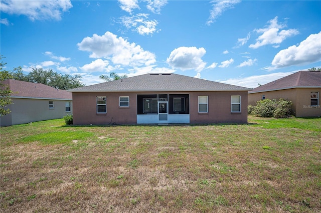 6339 Alamanda Hills Dr, Lakeland, FL 33813 - rear view of house featuring a lawn, a sunroom, and stucco siding