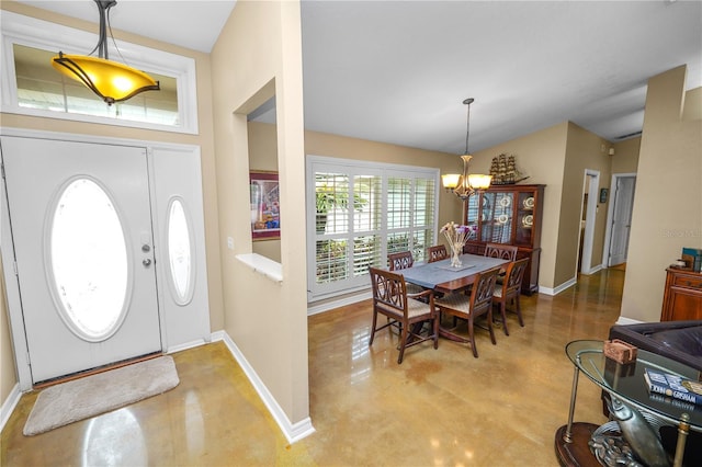1130 Ewell Rd, Lakeland, FL 33811 - entrance foyer with finished concrete flooring, baseboards, a chandelier, washer and dryer, and lofted ceiling