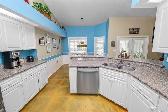 1130 Ewell Rd, Lakeland, FL 33811 - kitchen with dishwasher, a sink, finished concrete floors, white cabinetry, and hanging light fixtures