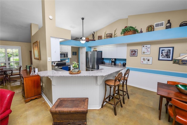 1130 Ewell Rd, Lakeland, FL 33811 - kitchen featuring stainless steel appliances, vaulted ceiling, white cabinets, a peninsula, and a ceiling fan
