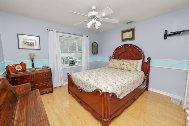 1130 Ewell Rd, Lakeland, FL 33811 - bedroom featuring light wood-style floors, wainscoting, and ceiling fan