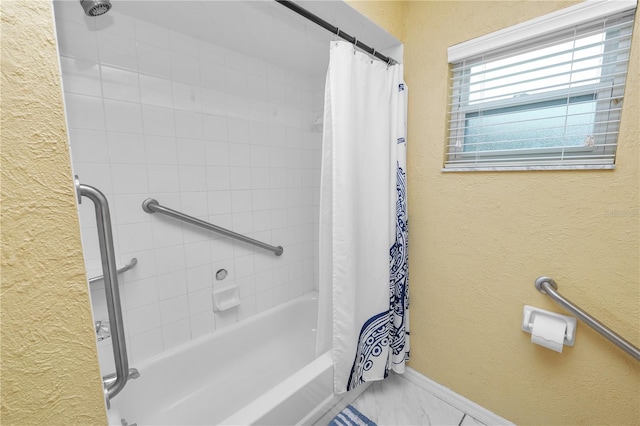 1130 Ewell Rd, Lakeland, FL 33811 - bathroom with a textured wall, shower / bath combination with curtain, baseboards, and marble look tile flooring