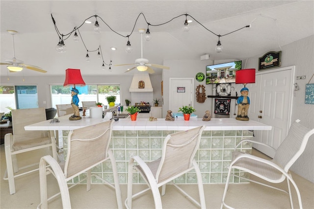 1130 Ewell Rd, Lakeland, FL 33811 - kitchen with ceiling fan, tile counters, and lofted ceiling