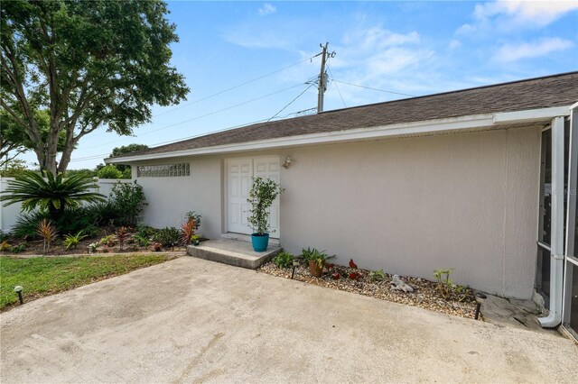 1130 Ewell Rd, Lakeland, FL 33811 - property entrance featuring a patio area and stucco siding