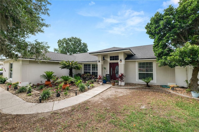 1130 Ewell Rd, Lakeland, FL 33811 - view of front of house with roof with shingles and stucco siding