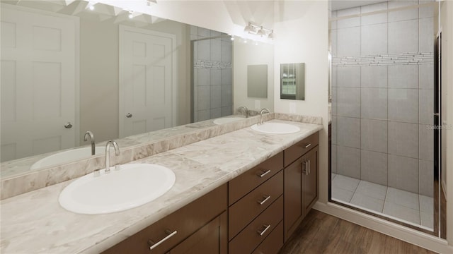 445 Silverbell Trl, Saint Cloud, FL 34771 - bathroom featuring double vanity, wood finished floors, and a tile shower