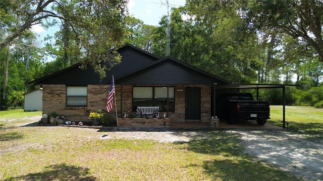 2430 Gresham St, Sebring, FL 33875 - view of front of house featuring a front lawn, a porch, an attached carport, and brick siding