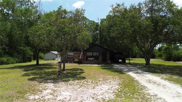 2430 Gresham St, Sebring, FL 33875 - view of front of house featuring a front lawn, driveway, and a carport