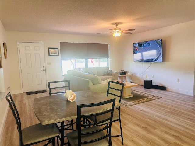 2430 Gresham St, Sebring, FL 33875 - dining room featuring light wood finished floors, ceiling fan, a textured ceiling, and baseboards