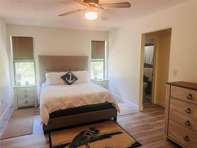 2430 Gresham St, Sebring, FL 33875 - bedroom featuring light wood finished floors, a textured ceiling, baseboards, ceiling fan, and connected bathroom