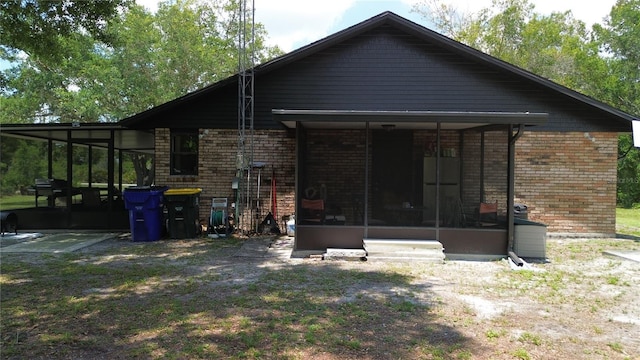 2430 Gresham St, Sebring, FL 33875 - back of house with a sunroom and brick siding