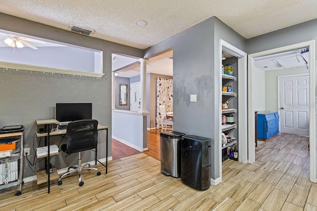 13411 Whitby Rd, Hudson, FL 34667 - office featuring wood finished floors, ceiling fan, a textured ceiling, and baseboards