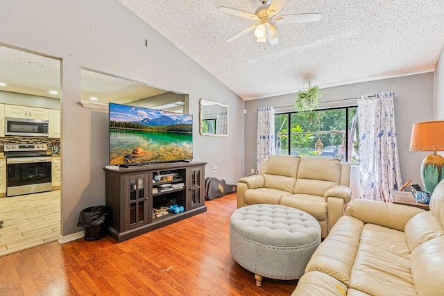 13411 Whitby Rd, Hudson, FL 34667 - living area featuring a textured ceiling, ceiling fan, lofted ceiling, and light wood-style flooring