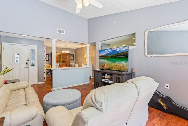 13411 Whitby Rd, Hudson, FL 34667 - living room with wood finished floors, decorative columns, a ceiling fan, a chandelier, and lofted ceiling
