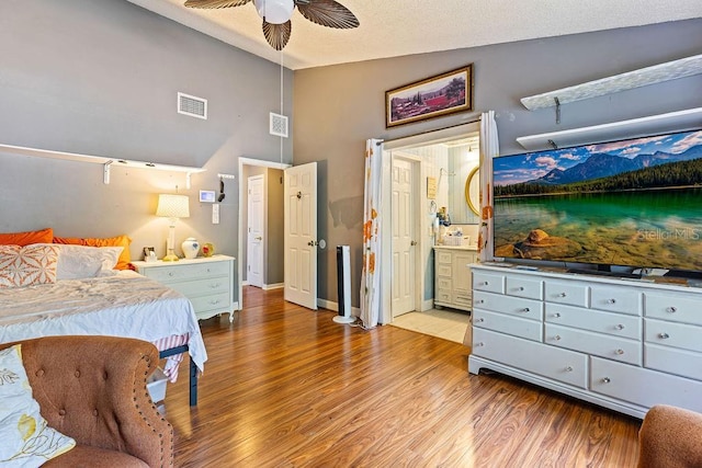 13411 Whitby Rd, Hudson, FL 34667 - bedroom featuring wood finished floors, vaulted ceiling, ceiling fan, ensuite bath, and baseboards