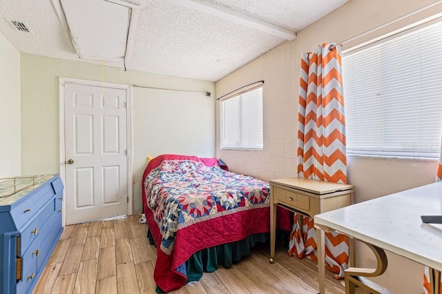 13411 Whitby Rd, Hudson, FL 34667 - bedroom with light wood-style flooring and a textured ceiling