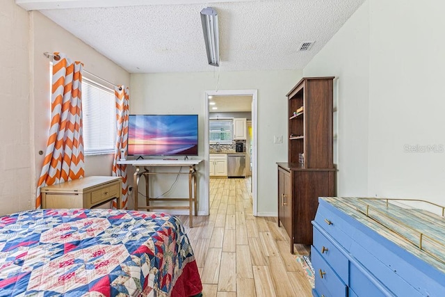 13411 Whitby Rd, Hudson, FL 34667 - bedroom featuring a textured ceiling and light wood finished floors