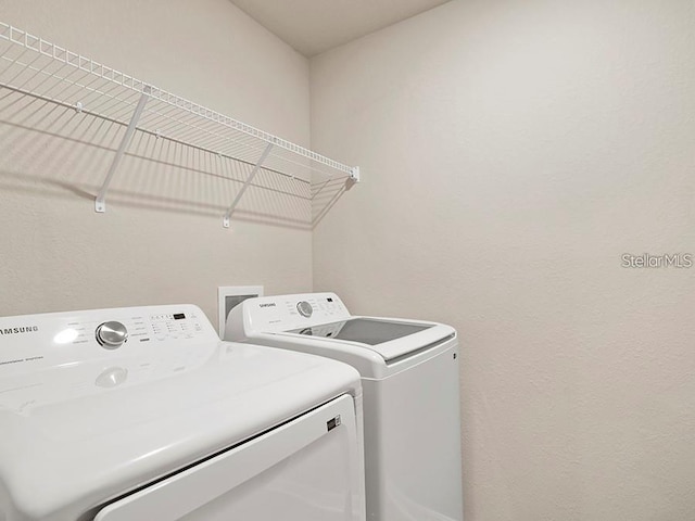 5771 Freshwater Canyon Dr, Saint Cloud, FL 34771 - laundry room featuring washer and clothes dryer