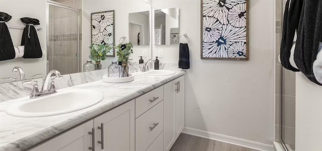 5768 Anders Way, Saint Cloud, FL 34771 - full bath featuring double vanity, wood finished floors, a shower stall, and baseboards