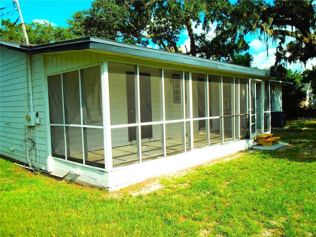4629 Harden Blvd, Lakeland, FL 33813 - view of side of home featuring a sunroom, a yard, and cooling unit