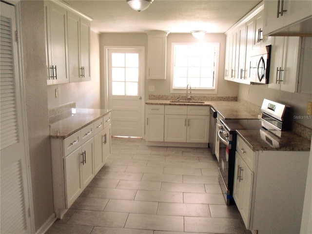 4629 Harden Blvd, Lakeland, FL 33813 - kitchen featuring appliances with stainless steel finishes, a sink, and white cabinets