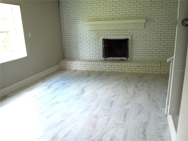 4629 Harden Blvd, Lakeland, FL 33813 - unfurnished living room featuring a fireplace and baseboards
