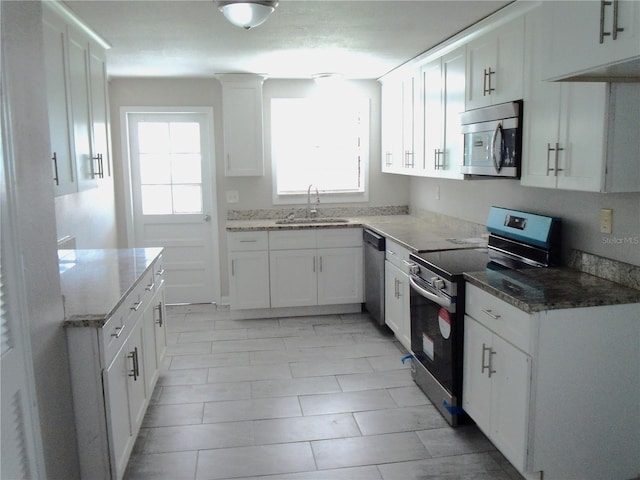4629 Harden Blvd, Lakeland, FL 33813 - kitchen featuring stainless steel appliances, a sink, light stone countertops, and white cabinets