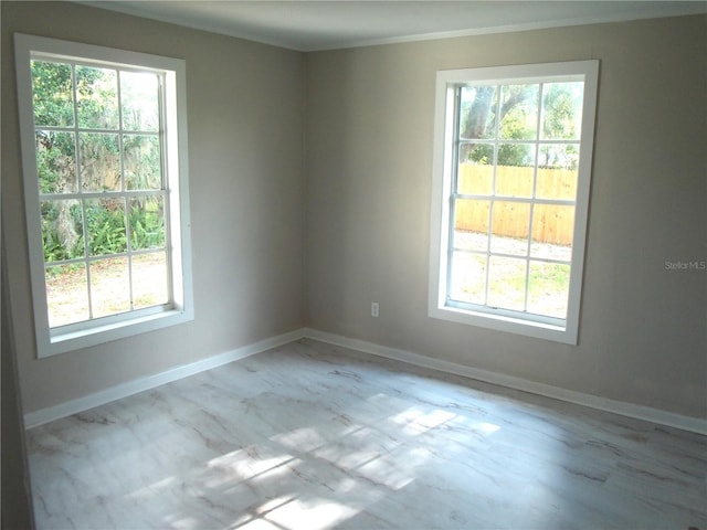 4629 Harden Blvd, Lakeland, FL 33813 - spare room featuring plenty of natural light, ornamental molding, baseboards, and marble finish floors