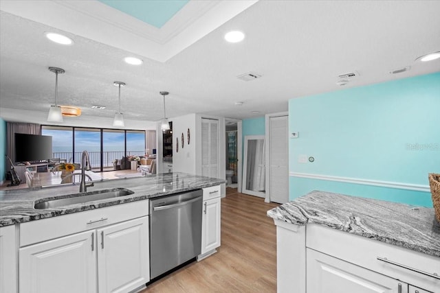 830 N Atlantic Ave Unit B502, Cocoa Beach, FL 32931 - kitchen with stainless steel dishwasher, a sink, white cabinetry, light wood-style flooring, and recessed lighting