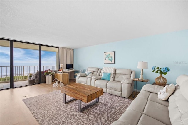 830 N Atlantic Ave Unit B502, Cocoa Beach, FL 32931 - living room featuring a wall of windows and wood finished floors