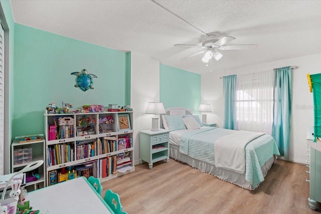 830 N Atlantic Ave Unit B502, Cocoa Beach, FL 32931 - bedroom featuring wood finished floors, a textured ceiling, and a ceiling fan