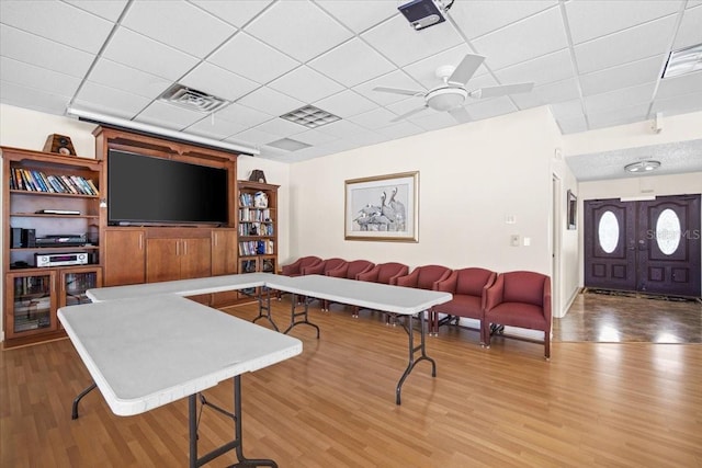 830 N Atlantic Ave Unit B502, Cocoa Beach, FL 32931 - living room featuring wood finished floors, a drop ceiling, a ceiling fan, and baseboards