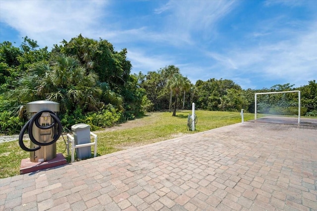 830 N Atlantic Ave Unit B502, Cocoa Beach, FL 32931 - view of community featuring a yard, a carport, and decorative driveway