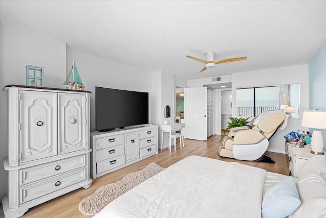 830 N Atlantic Ave Unit B502, Cocoa Beach, FL 32931 - bedroom with light wood-style flooring and ceiling fan