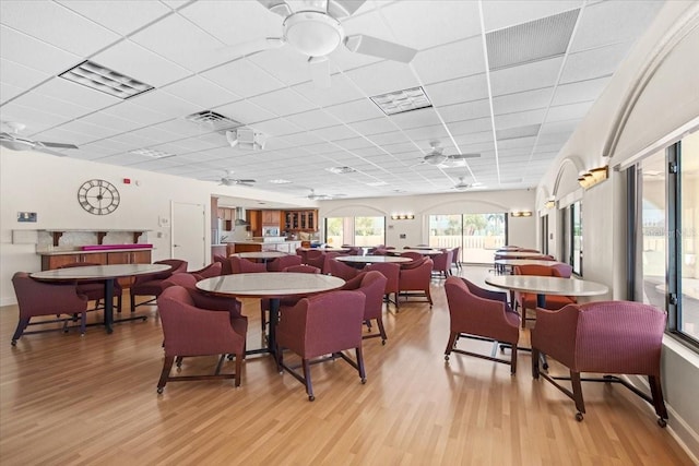 830 N Atlantic Ave Unit B502, Cocoa Beach, FL 32931 - dining space featuring a ceiling fan, light wood-style floors, and a drop ceiling