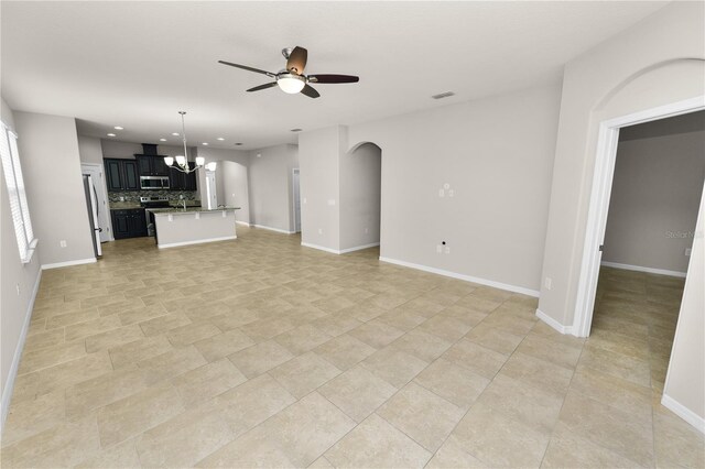 4125 Prima Lago Cir, Lakeland, FL 33810 - unfurnished living room with a ceiling fan, arched walkways, a chandelier, recessed lighting, and baseboards