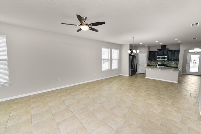 4125 Prima Lago Cir, Lakeland, FL 33810 - unfurnished living room with a chandelier, ceiling fan, healthy amount of natural light, recessed lighting, and baseboards