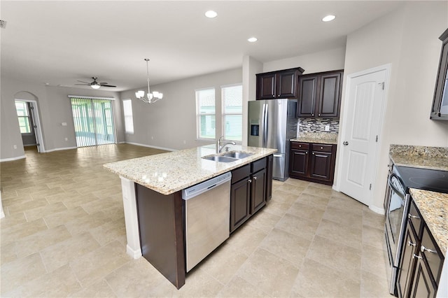 4125 Prima Lago Cir, Lakeland, FL 33810 - kitchen with appliances with stainless steel finishes, a sink, baseboards, dark brown cabinets, and a center island with sink