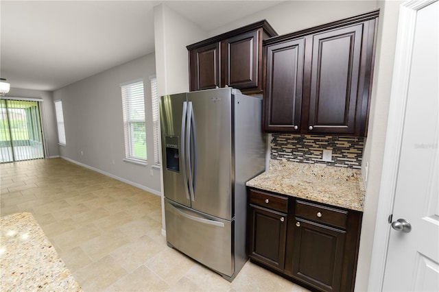 4125 Prima Lago Cir, Lakeland, FL 33810 - kitchen with stainless steel fridge with ice dispenser, tasteful backsplash, plenty of natural light, and dark brown cabinetry