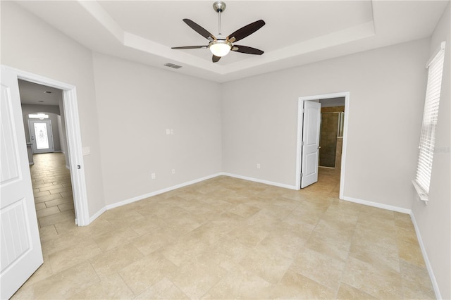 4125 Prima Lago Cir, Lakeland, FL 33810 - unfurnished bedroom featuring a raised ceiling, multiple windows, and baseboards