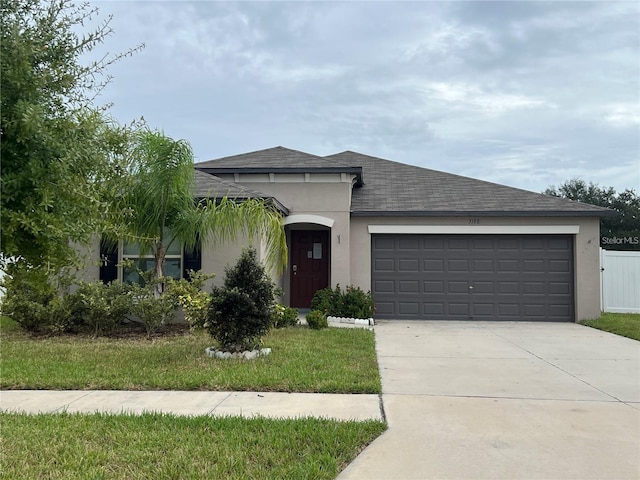 3188 Nubbin Ridge Ln, Zephyrhills, FL 33540 - view of front of property featuring stucco siding, concrete driveway, an attached garage, and a shingled roof