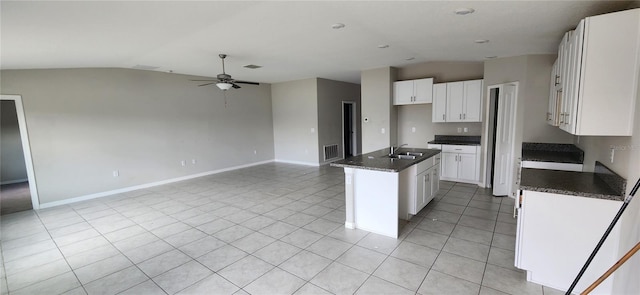 3188 Nubbin Ridge Ln, Zephyrhills, FL 33540 - kitchen with vaulted ceiling, a ceiling fan, light tile patterned floors, open floor plan, and white cabinetry