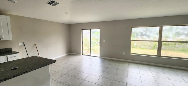 3188 Nubbin Ridge Ln, Zephyrhills, FL 33540 - unfurnished dining area featuring baseboards and light tile patterned floors