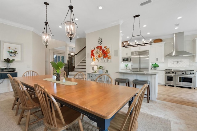1825 Pawnee Trl, Lakeland, FL 33803 - dining room featuring a chandelier, crown molding, recessed lighting, and stairs