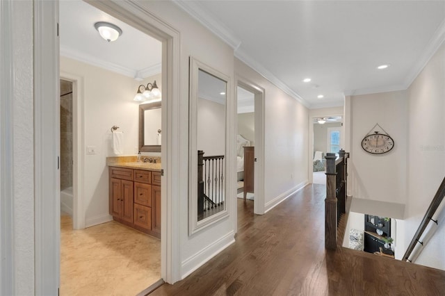 1825 Pawnee Trl, Lakeland, FL 33803 - corridor featuring an upstairs landing, a sink, recessed lighting, ornamental molding, and baseboards
