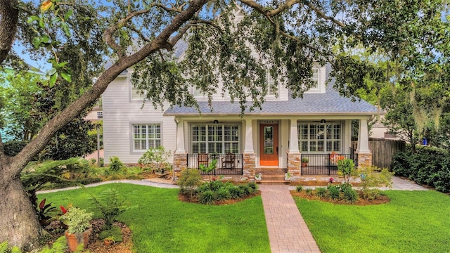 1825 Pawnee Trl, Lakeland, FL 33803 - view of front facade featuring covered porch, stone siding, and a shingled roof