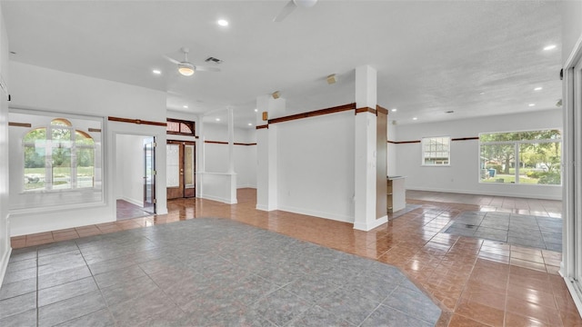 5370 Boxtree Ct, Dade City, FL 33523 - empty room featuring ceiling fan, a barn door, tile patterned floors, recessed lighting, and baseboards