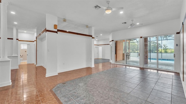 5370 Boxtree Ct, Dade City, FL 33523 - empty room with ceiling fan, ornate columns, baseboards, a barn door, and recessed lighting