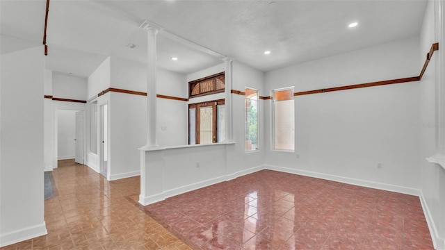 5370 Boxtree Ct, Dade City, FL 33523 - unfurnished room featuring ornate columns, baseboards, and recessed lighting